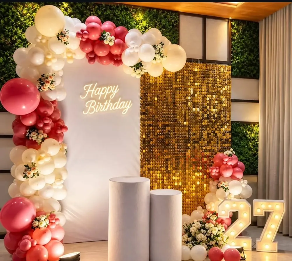 Birthday balloon arch decoration with pink and white balloons, neon Happy Birthday sign and gold sequin wall in Patna